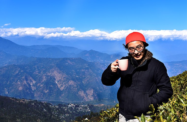 Benoy drinking tea in a tea garden